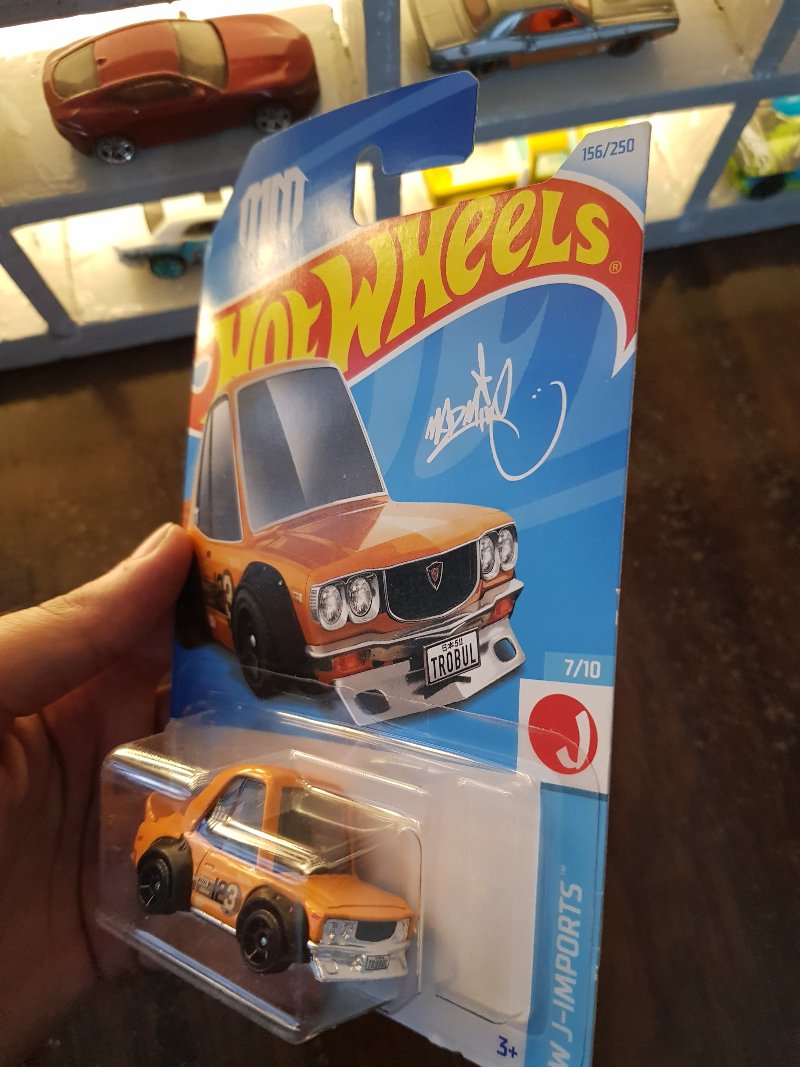 Angled view of Hot Wheels Mazda RX-3 Orange die-cast model
