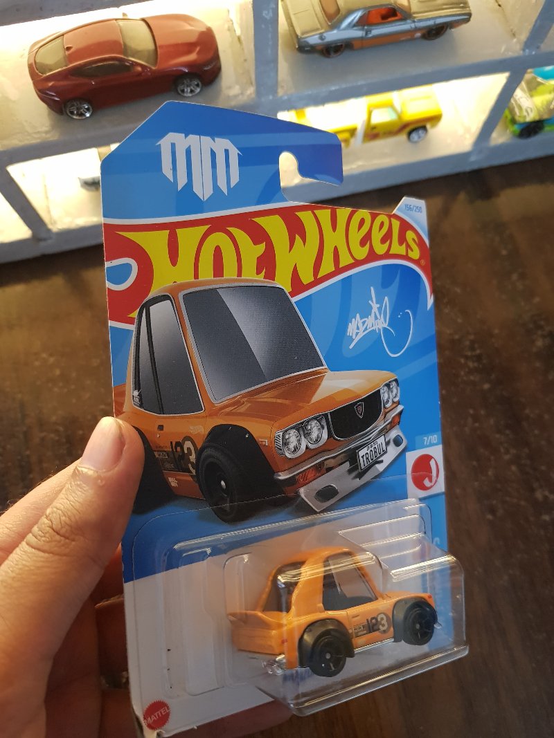 Rear view of Hot Wheels Mazda RX-3 Orange die-cast model
