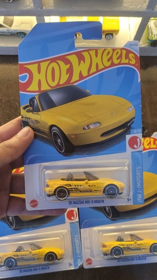 Front view of Hot Wheels Mainline 1991 Mazda MX-5 Miata yellow die-cast car