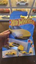 Side view of Hot Wheels Mainline 1991 Mazda MX-5 Miata in yellow